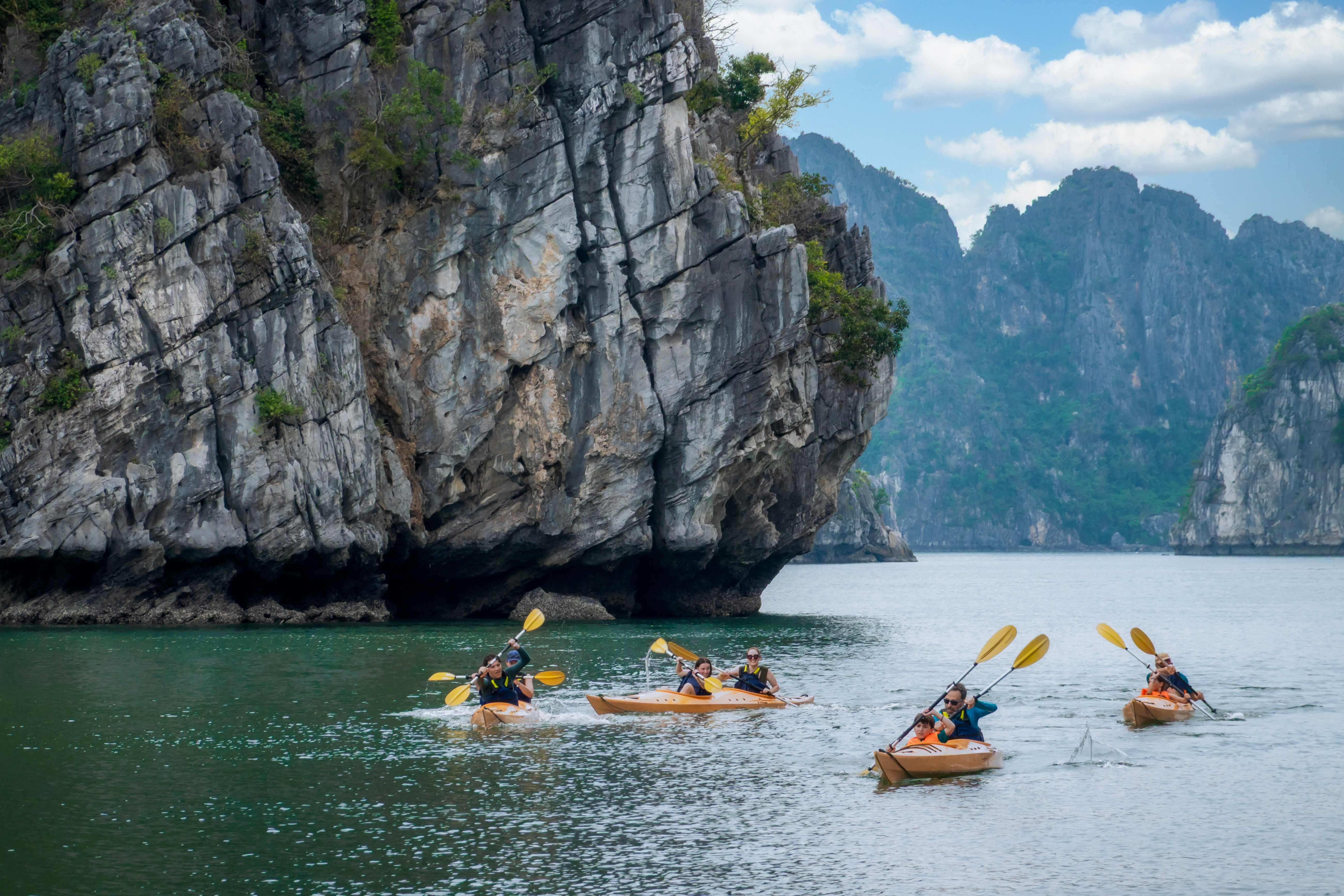 Bai Tu Long Bay kayaking experience with scenic limestone formations and emerald water
