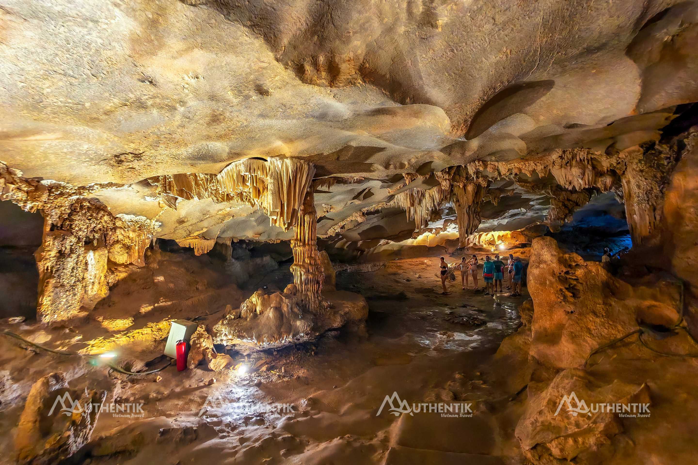 Visitors exploring Thien Canh Son Cave in Bai Tu Long Bay