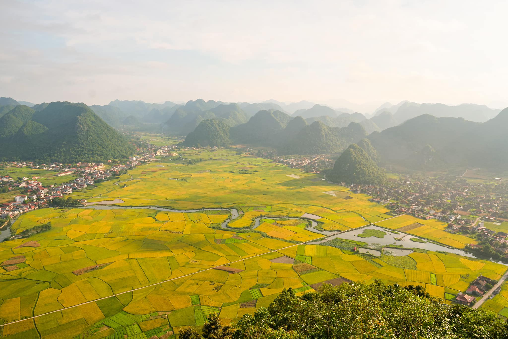 From the summit of Na Lay Mountain, the panoramic view of Bac Son Valley unfolds in a serene embrace of vibrant and enchanting colours