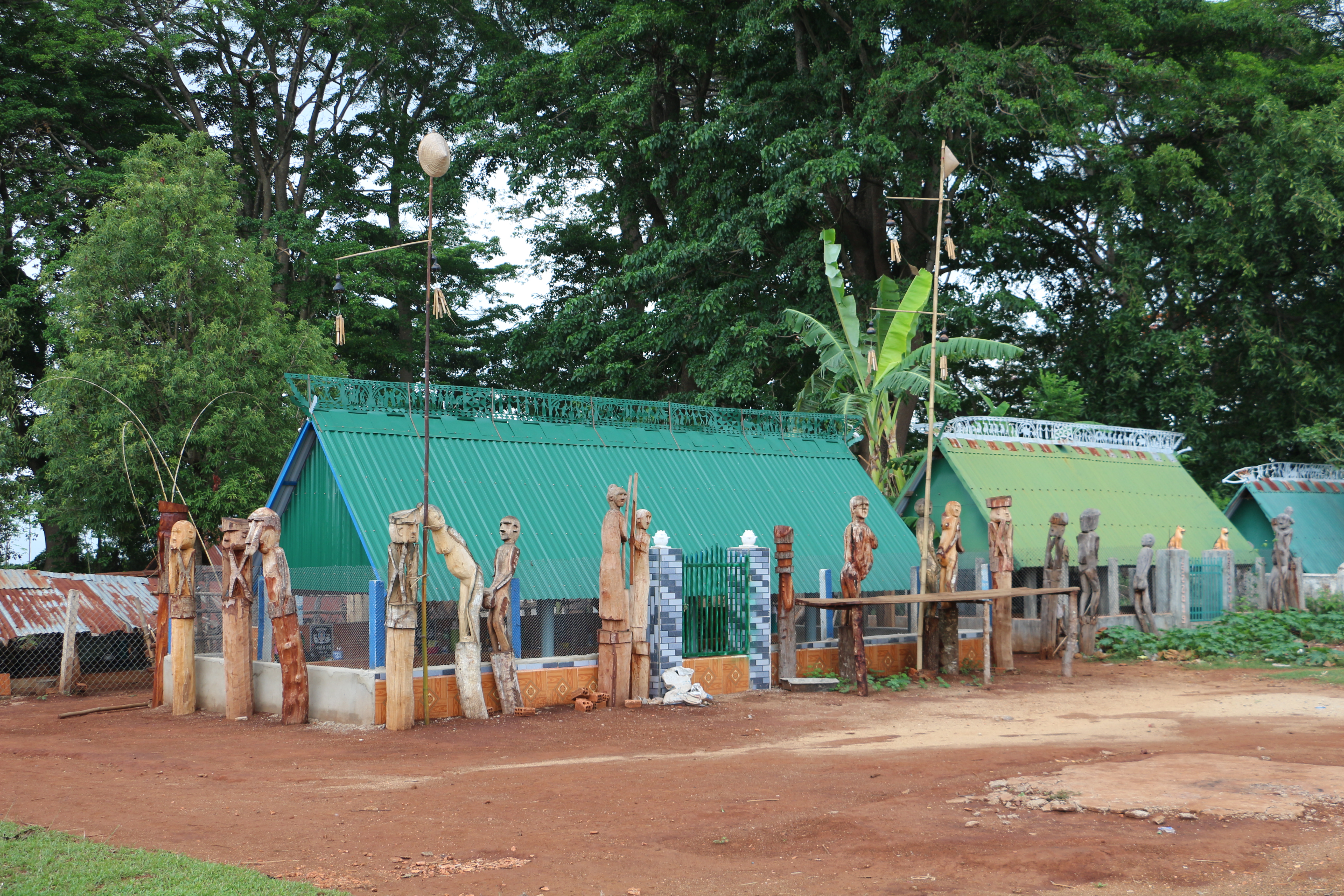 In the village, a funerary house like this can serve as the burial place for around 30 deceased individuals. It is enclosed by a fence of wooden statues, carved using axes, chisels, and knives. The sculptures depict couples in intimate poses, figures emphasizing fertility, and pregnant women &mdash; all symbolizing reproduction, renewal, and the continuation of life.