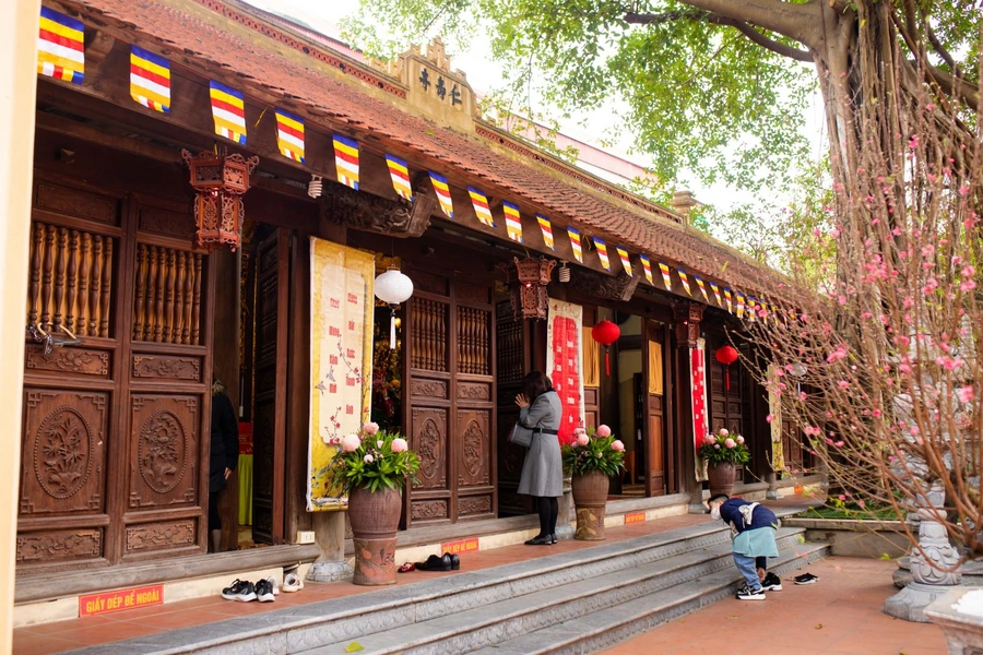 Removing shoes at a Vietnamese temple following local etiquette